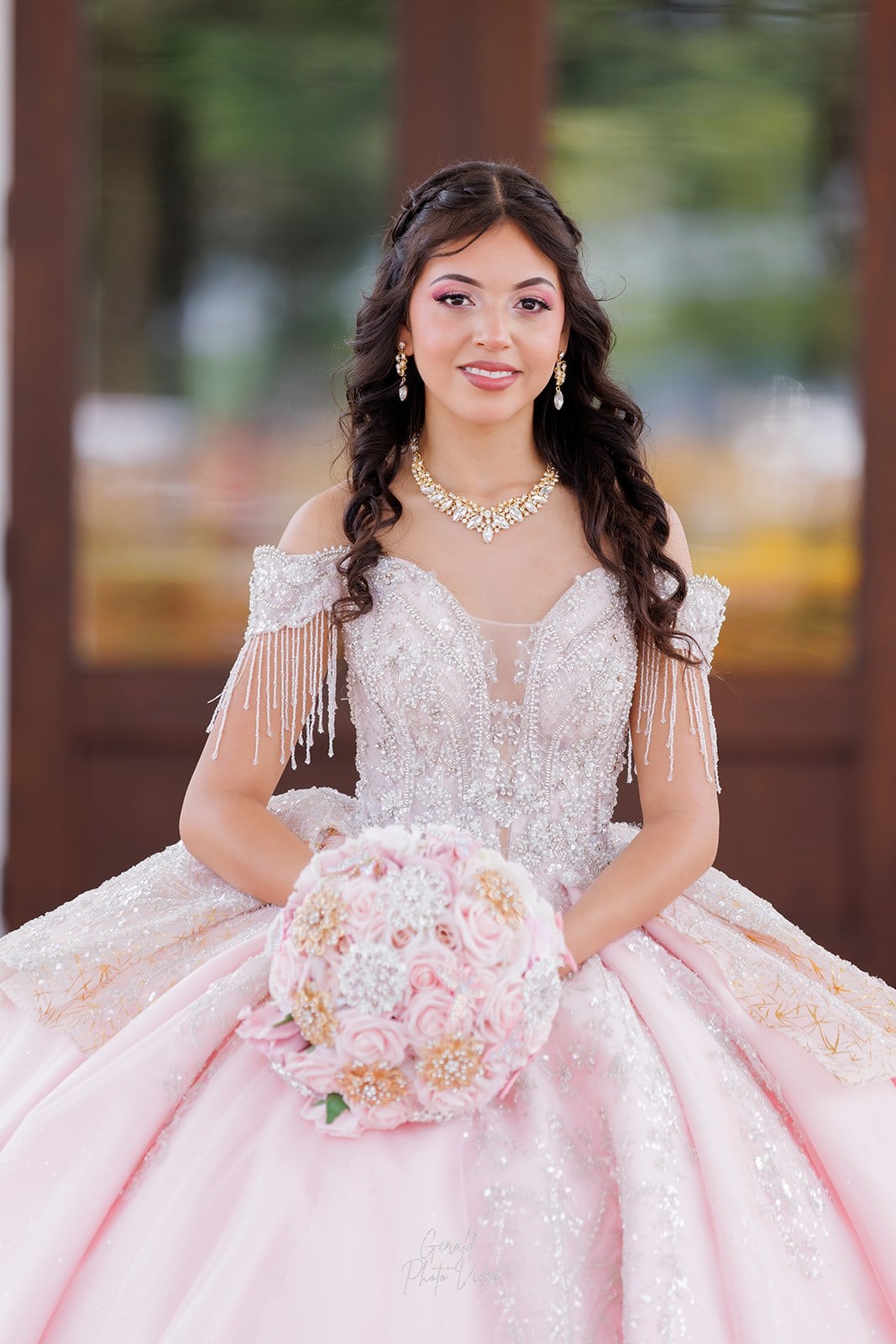 Close portrait of a quinceañera in a beaded blush gown with a rose and crystal bouquet at Glen Oaks Country Club, West Des Moines quinceañera photographer